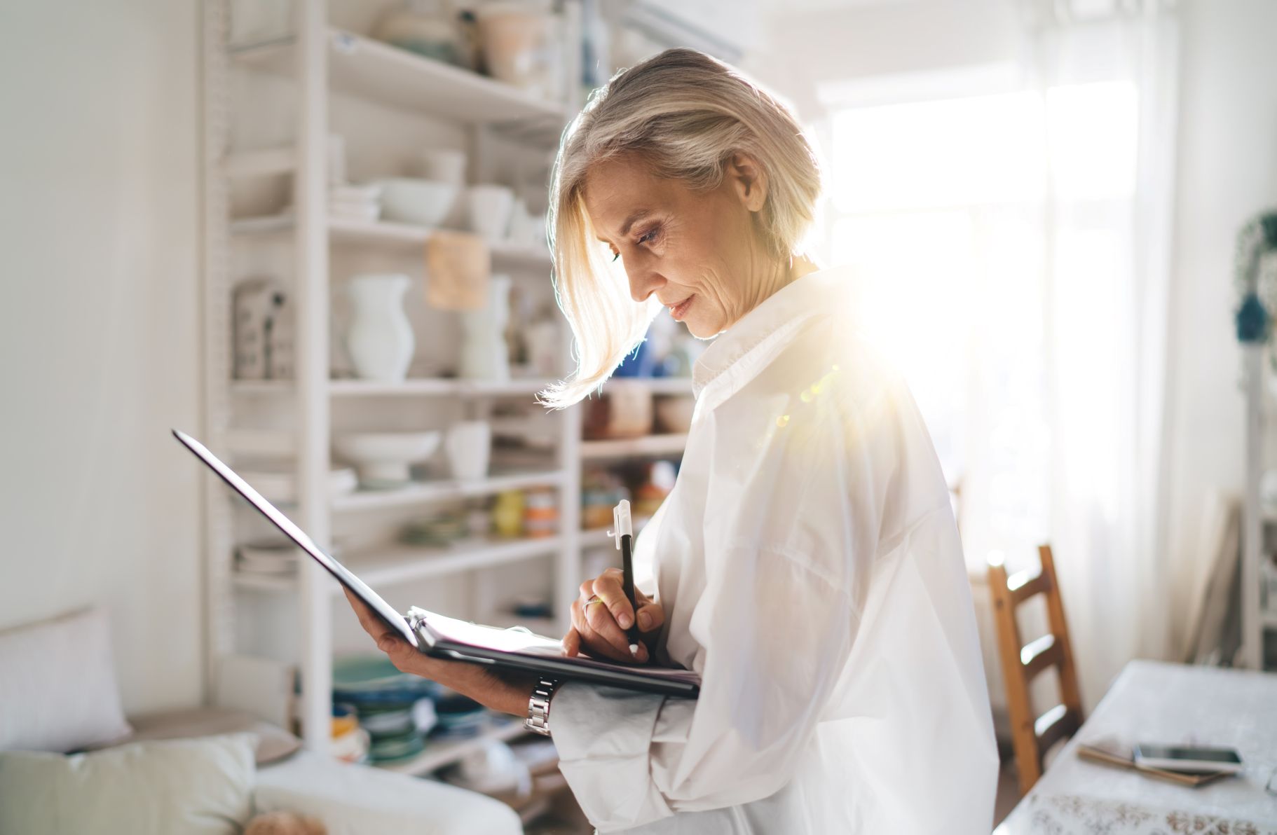 Businesswoman with clipboard working at art studio